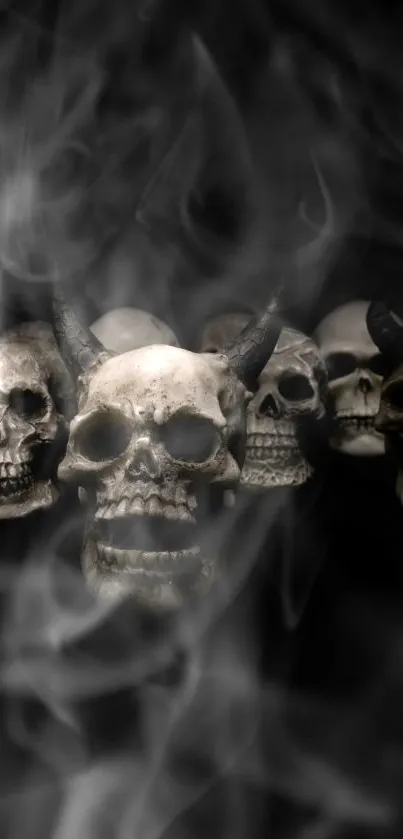 Eerie skulls with horns surrounded by smoke on a dark background.