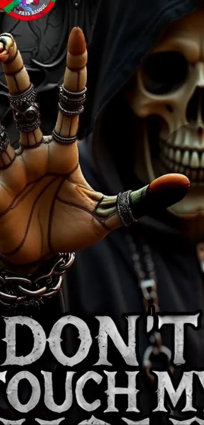 Gothic skull with metallic hand on wallpaper.