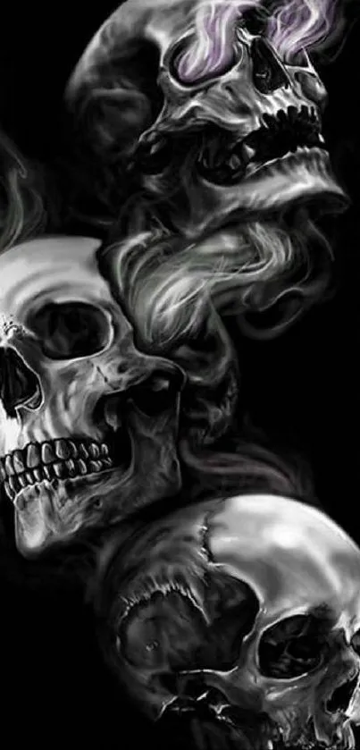 Artistic wallpaper featuring skulls with smoke on a dark background.