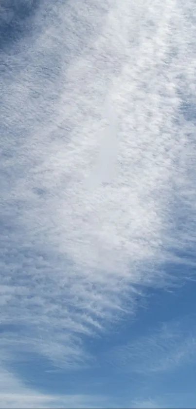 Serene blue sky with textured clouds.