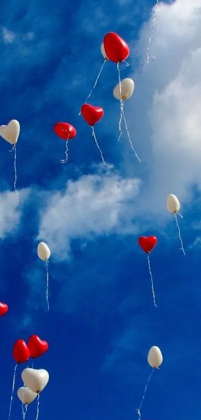 Heart-shaped balloons floating in the blue sky with white clouds.