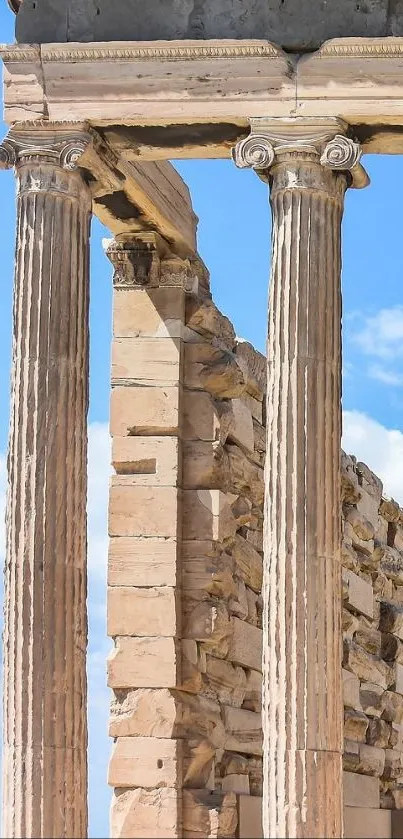 Ancient Greek columns under a vibrant blue sky with clouds.