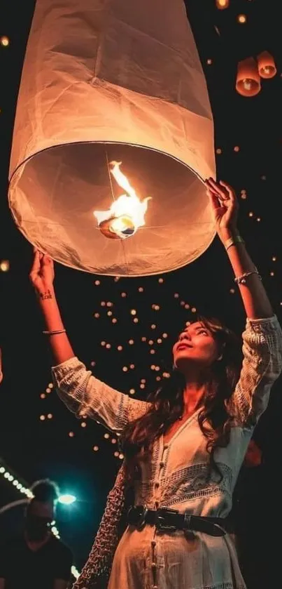 A woman releases a glowing lantern into the starry sky at a night festival.