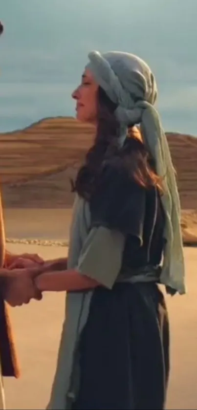 Couple in a romantic desert scene, holding hands at sunset.