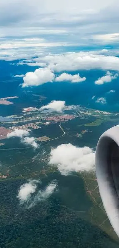 Aerial view of landscape from an airplane window, featuring clouds and sky.