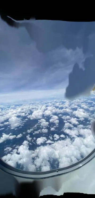 View from airplane window showing clouds and blue sky.