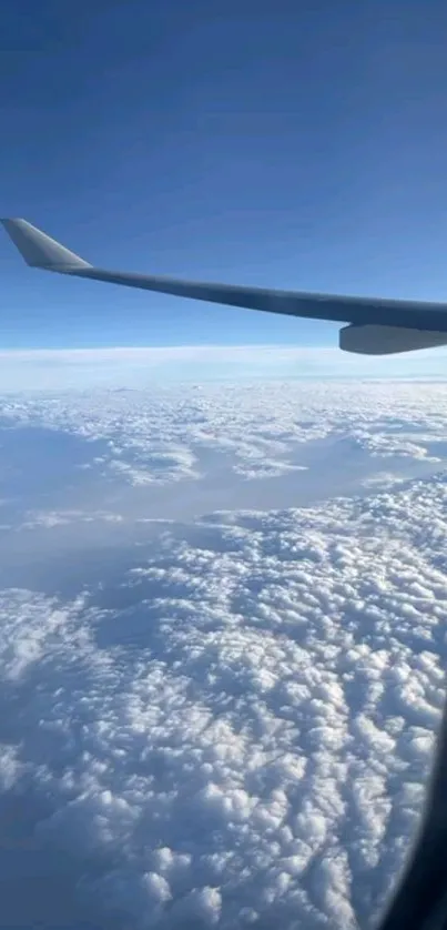 Airplane wing view with clouds below.