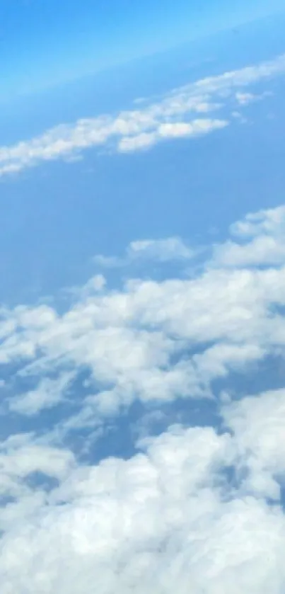 A serene airplane window view with blue sky and fluffy clouds.