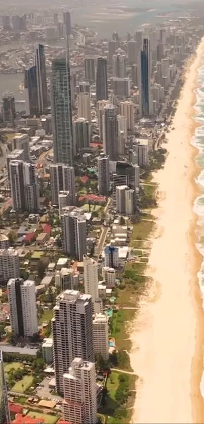 Aerial view of city skyline and sandy beach with turquoise waves.