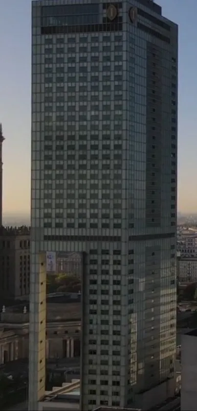 Mobile wallpaper of a modern skyscraper and urban skyline at dusk.