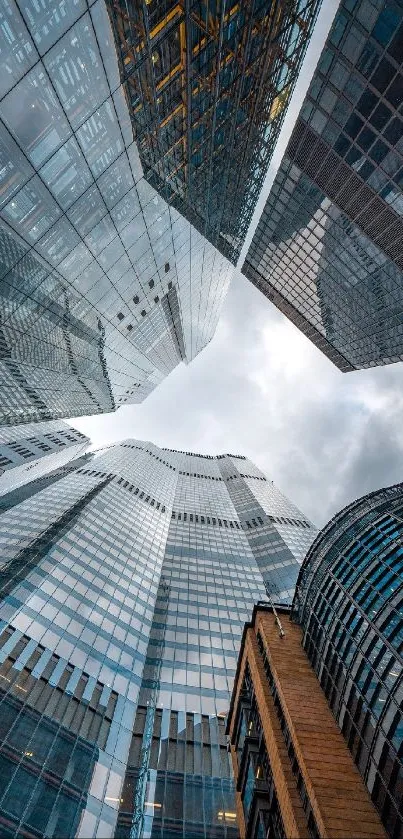 Dynamic skyscrapers with reflective glass and cloudy sky.