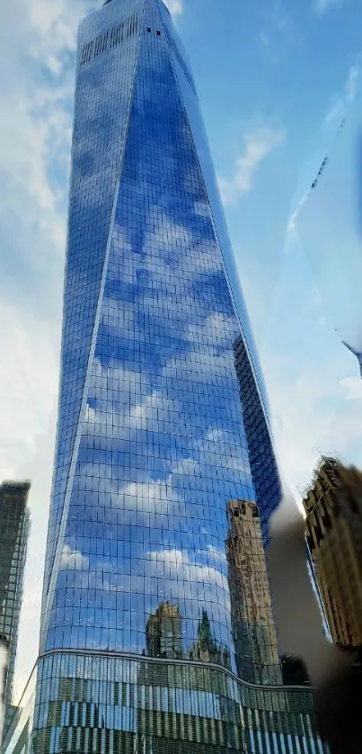 Skyscraper reflecting a cloudy blue sky in the city.