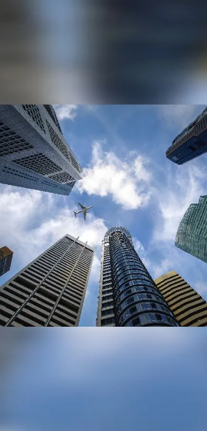 View of skyscrapers and a flying airplane in a blue sky.