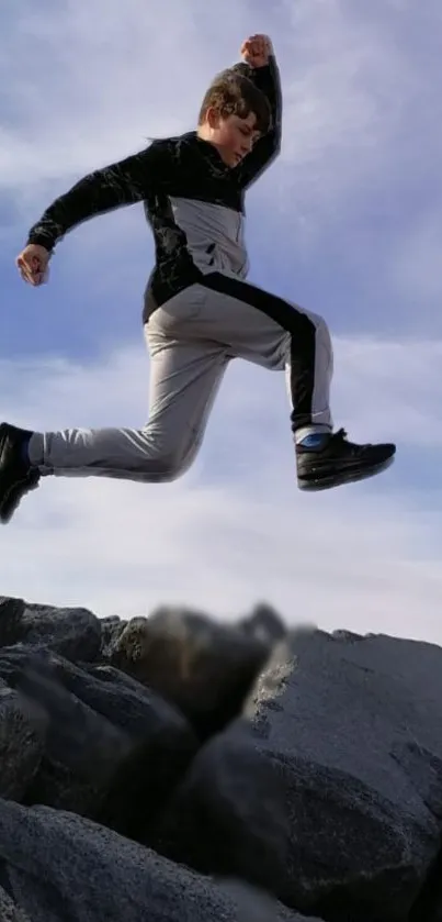 Person leaping over rocks against a sky backdrop.