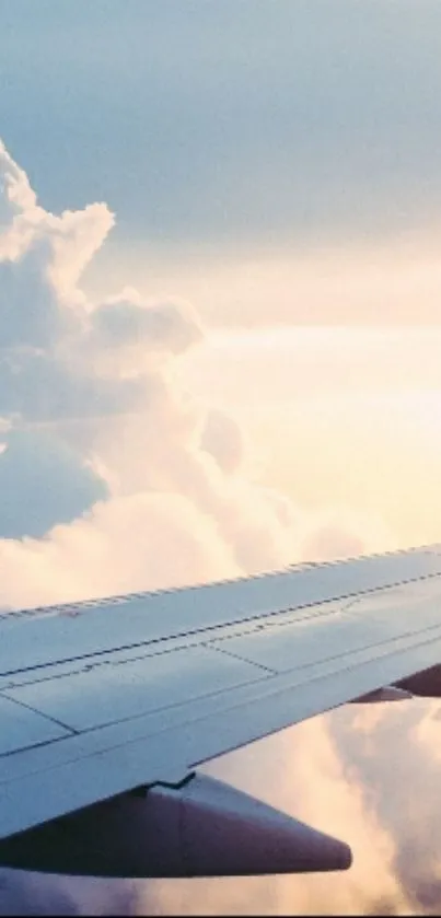 Airplane wing over clouds with a pastel sky background.