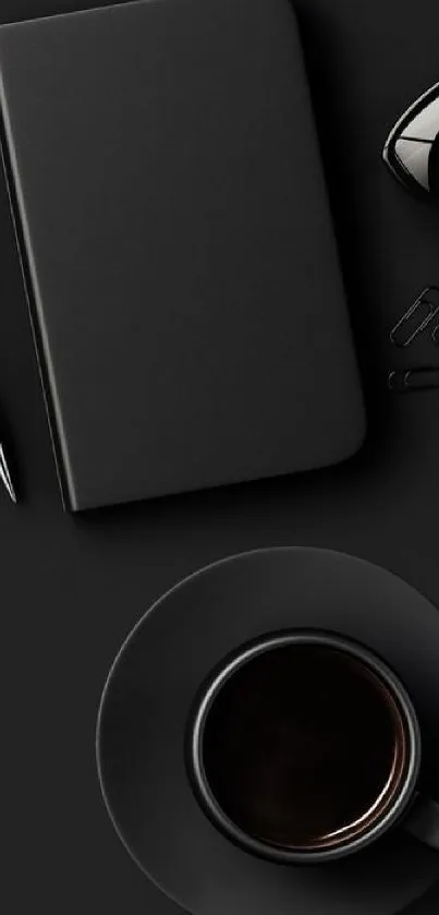 Minimalist black wallpaper with coffee cup and notebook.