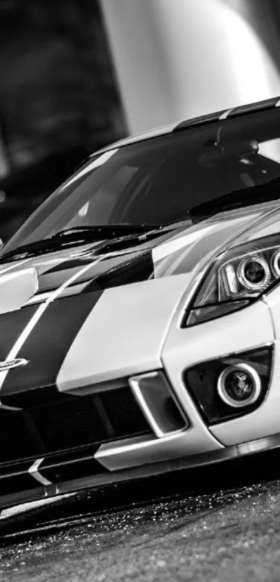 Sleek black and white car with bold stripes.