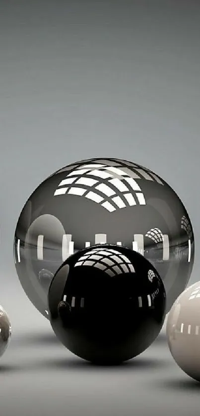 Glossy black and white spheres with reflections on a minimalist gray background.