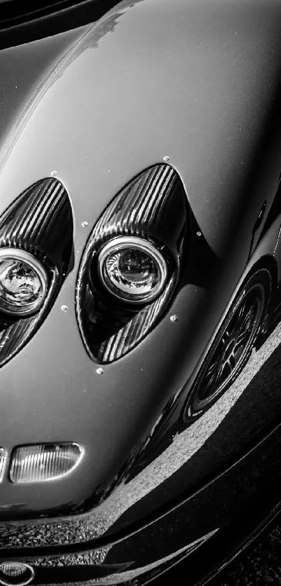 Close-up of a sleek, black car with artistic reflections.