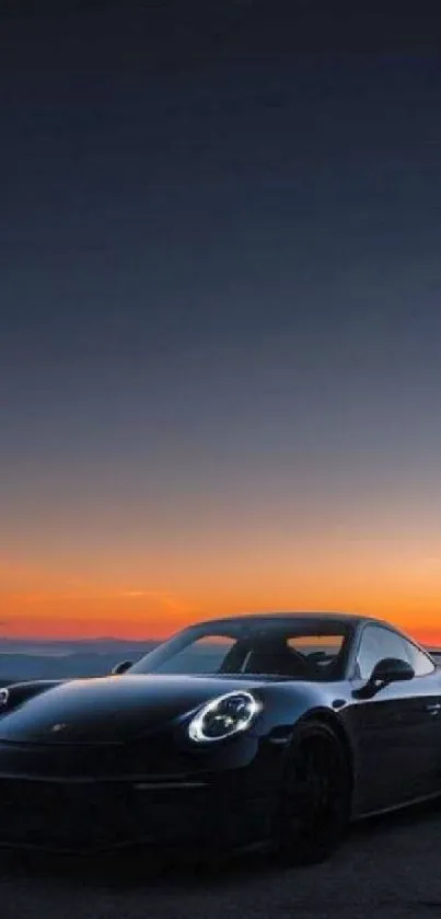 Sleek black car against a sunset backdrop on the road.