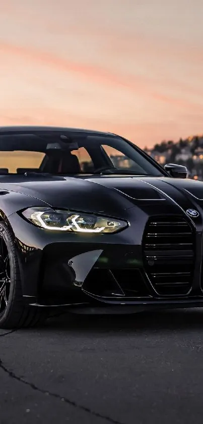 Sleek black car parked at sunset with mountains in the background.