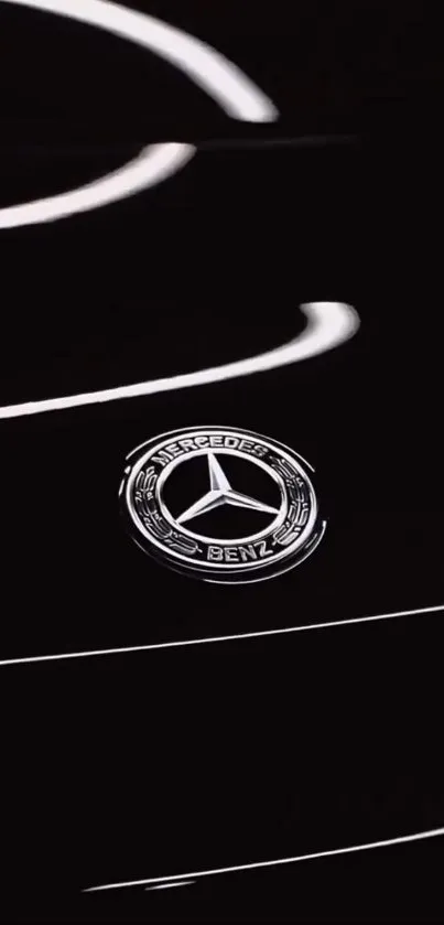 Black car with Mercedes-Benz emblem in focus.