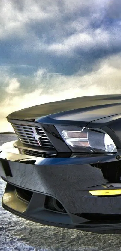 Sleek black car with a dramatic sky background.