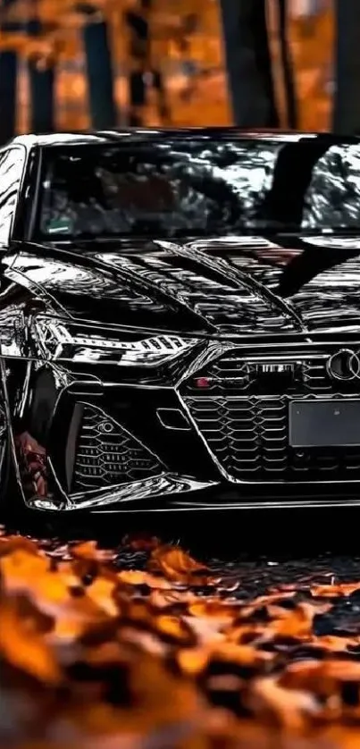 Sleek black car parked among autumn leaves.