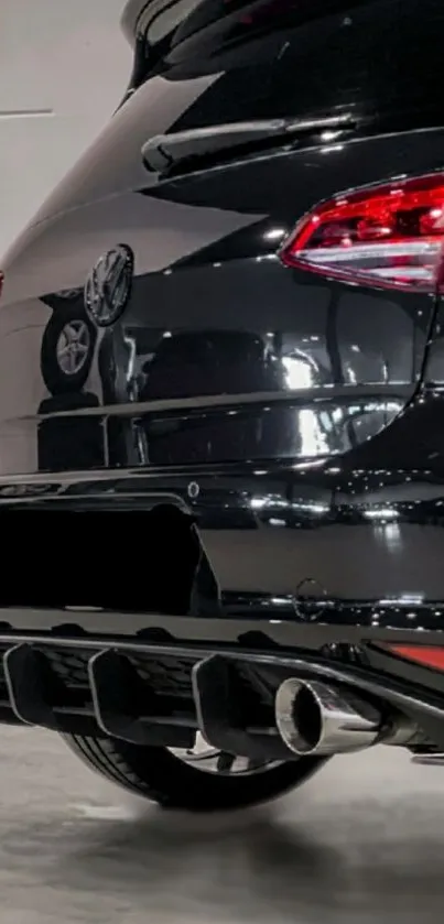 Close-up of a sleek black car rear with a shiny tailpipe.