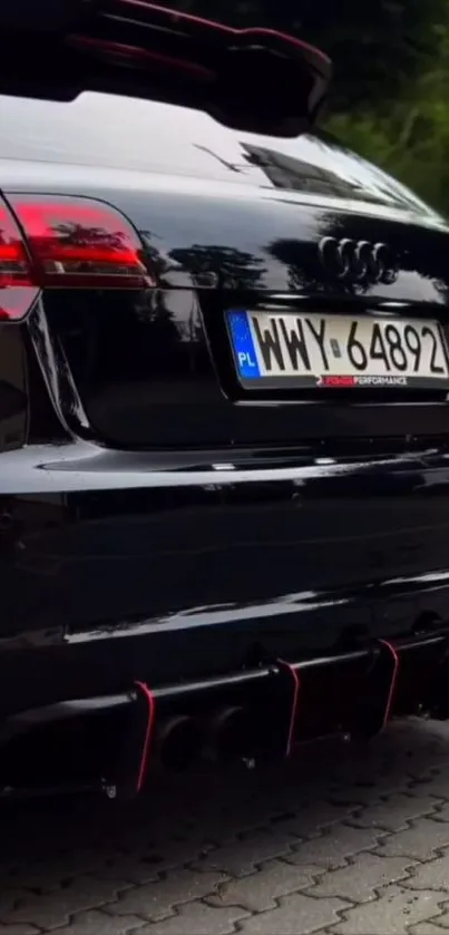 Sleek black car rear view with red taillights and polished finish.