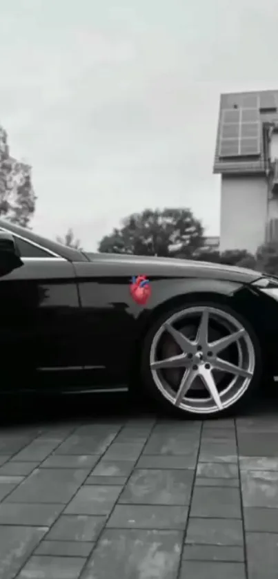 Sleek black car parked in urban setting with stylish design elements.