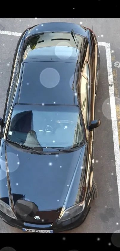 Aerial view of a sleek black car parked.