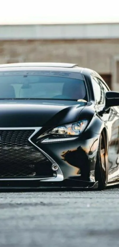 Sleek black luxury car parked outdoors.