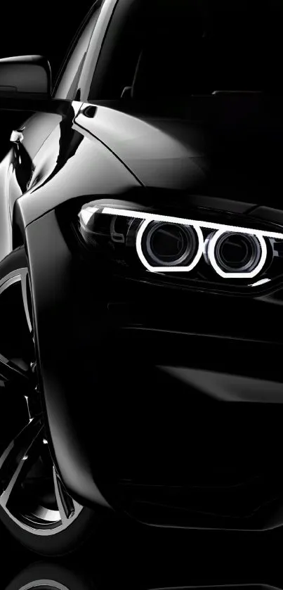 Sleek black car with glowing headlights.