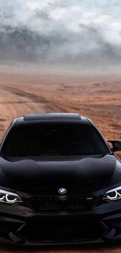 Sleek black car on a dirt road with dramatic cloudy sky.