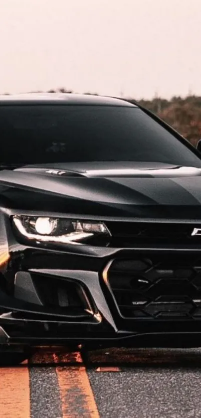 Sleek black Chevrolet car on a scenic road wallpaper.