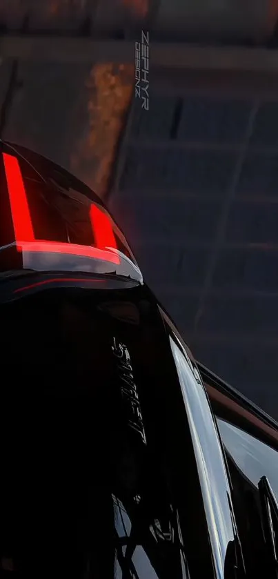 Sleek black car wallpaper with red taillights.