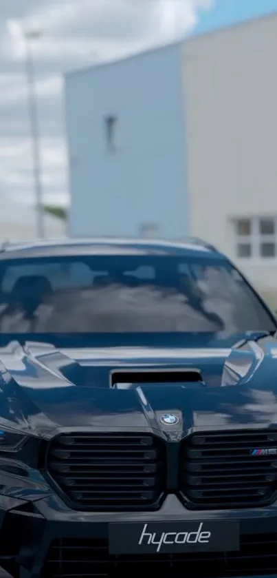 Sleek black luxury car with blue accents in a modern setting.