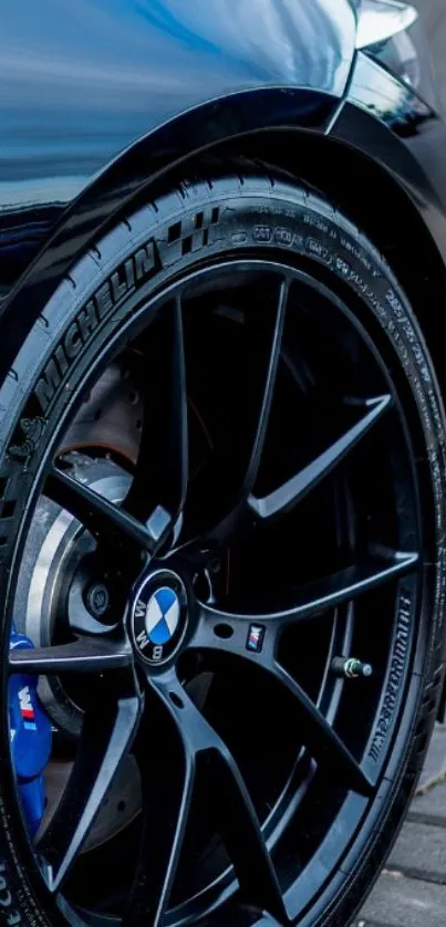 Close-up of a sleek black car wheel and tire.