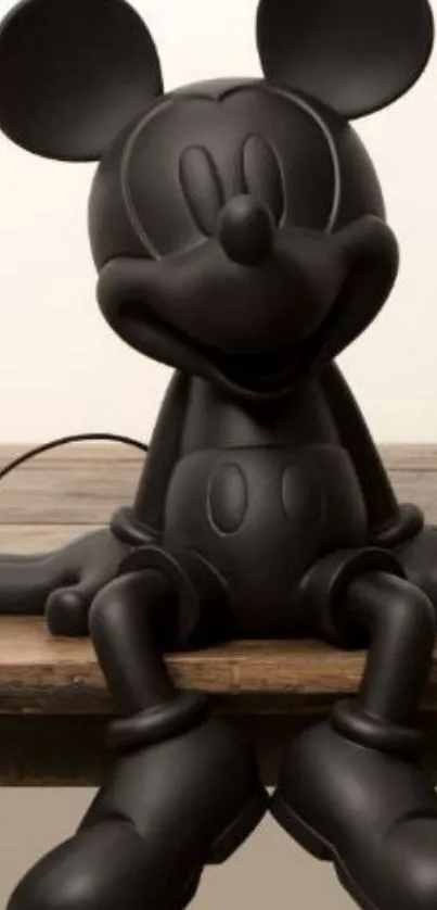 Sleek black cartoon figure on a wooden surface.