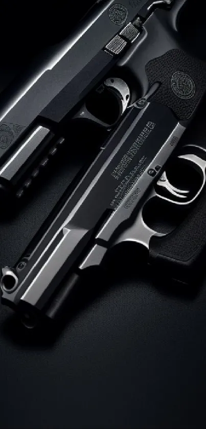 Two sleek black firearms on a dark background.