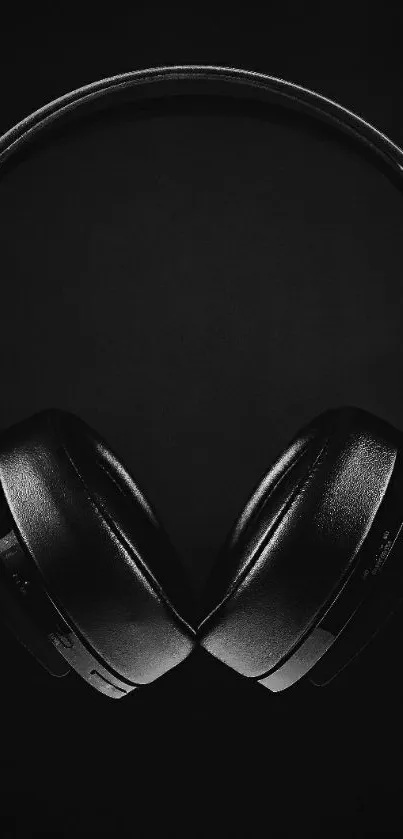 Sleek black headphones on dark background.