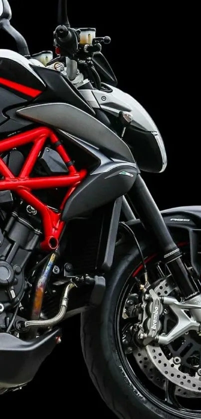 Black sport motorcycle with red accents on a black background.