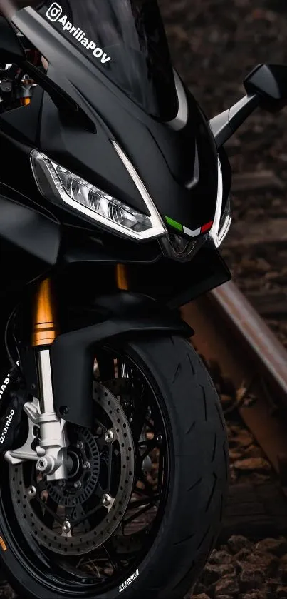 Sleek black motorcycle on railway track with vivid details.