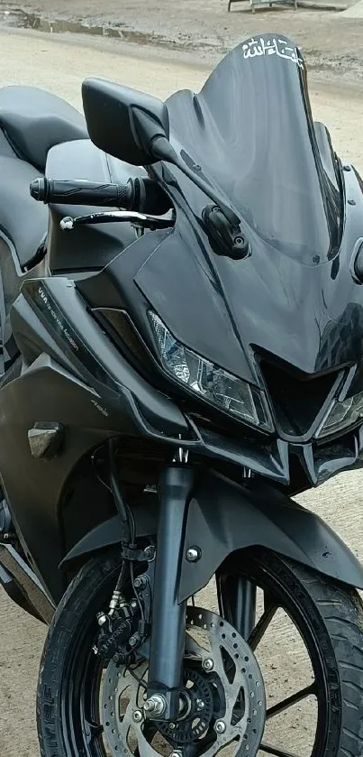 Sleek black motorcycle parked on asphalt road, showcasing its dynamic design.