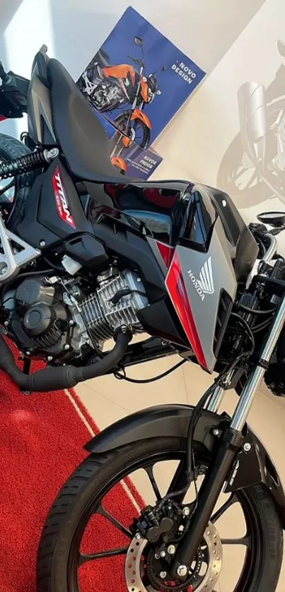 Sleek black motorcycle with red accents on a showroom floor.