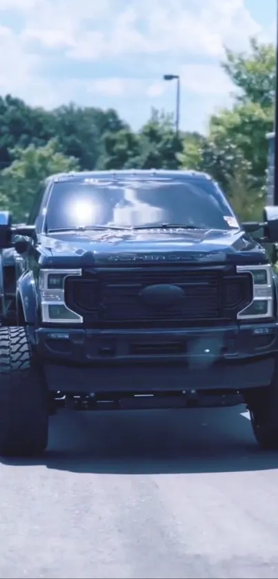 Sleek black pickup truck on open road.