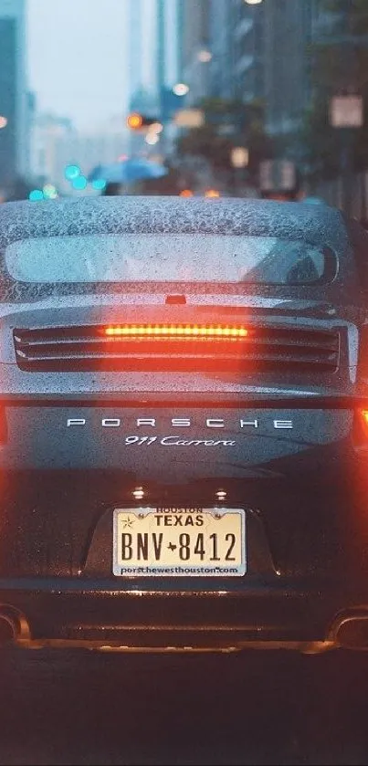 Rainy cityscape with Porsche 911 tail lights aglow.