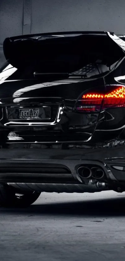 A sleek black sports car in a garage, perfect for mobile wallpaper.