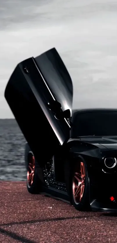 Black sports car with open door by the sea.